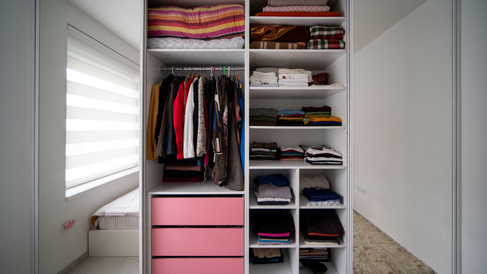 Small bedroom with smart vertical storage and an organized closet